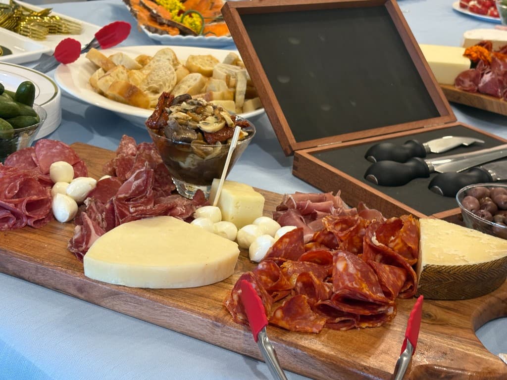 Italian meats, cheeses, olives, and accompaniments on a charcuterie board