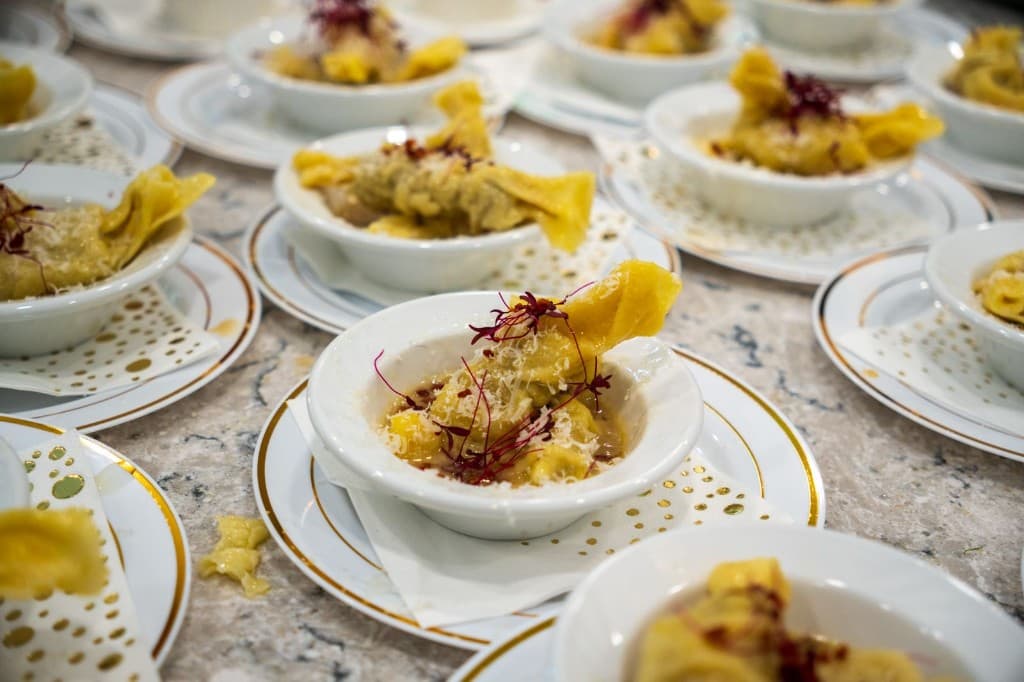 Plated tortellini course arranged in small bowls