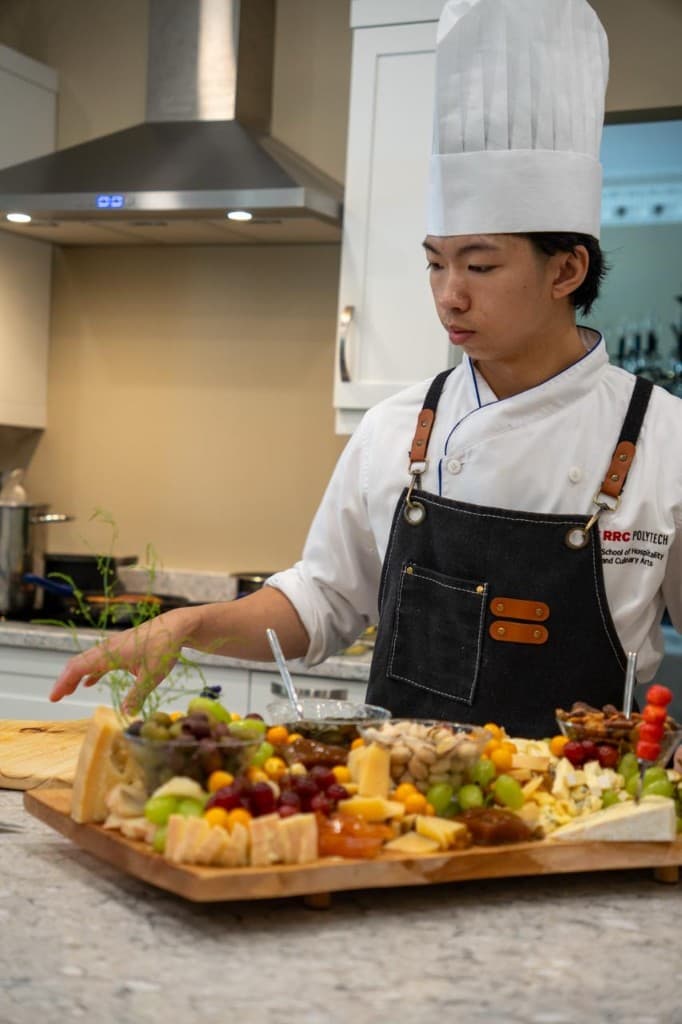 Chef preparing a charcuterie and cheese board