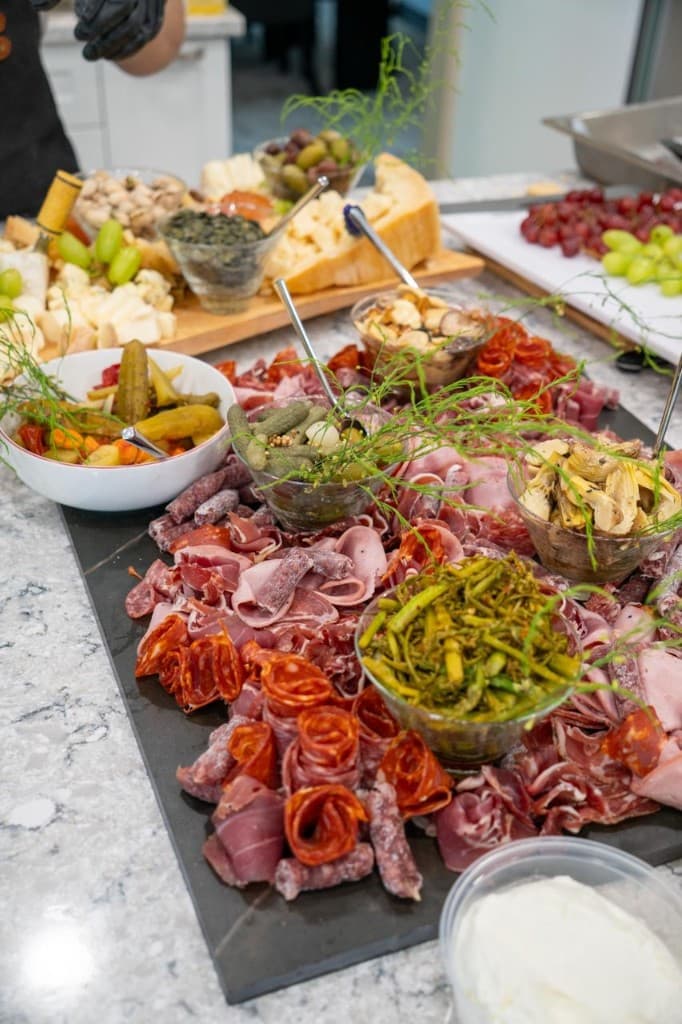 Charcuterie board with meats, cheeses, olives, and accompaniments