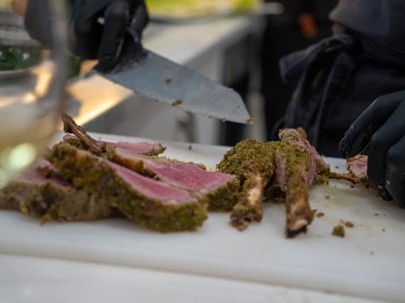 Premium ribeye being carved on a cutting board