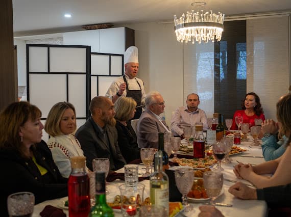 Chef Sergei speaking to guests seated around a private dinner table