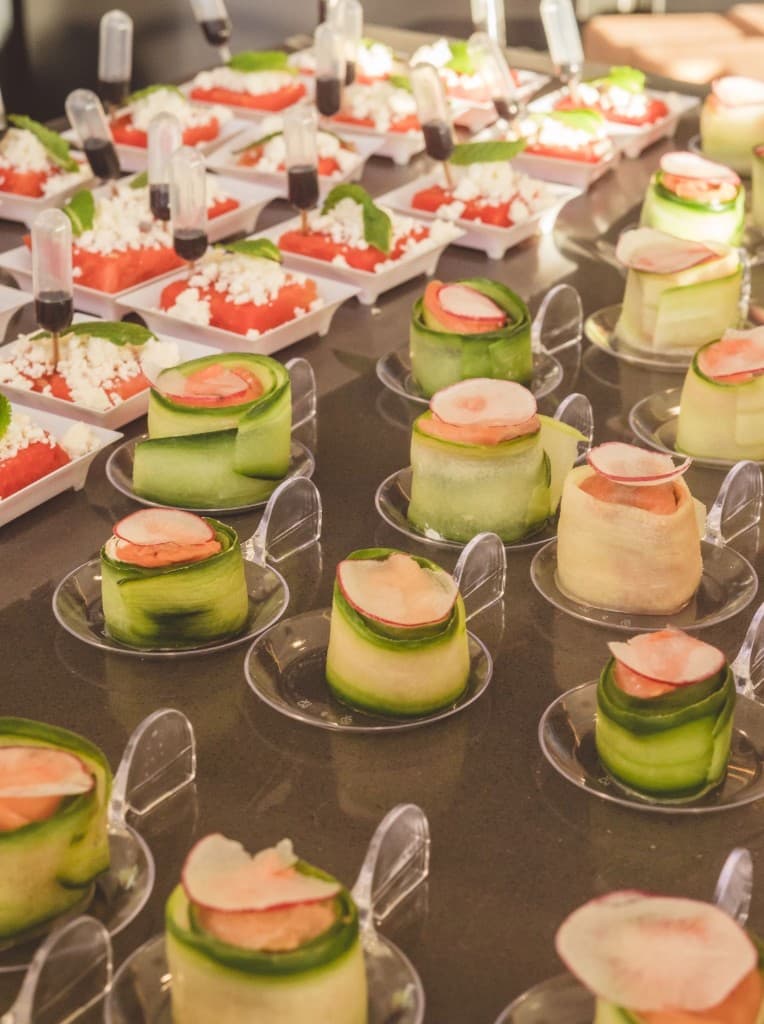 Cucumber-wrapped appetizers and watermelon bites arranged for guests
