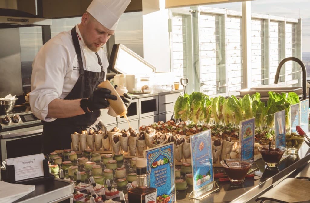 Chef Sergei finishing a Mediterranean-inspired catering station