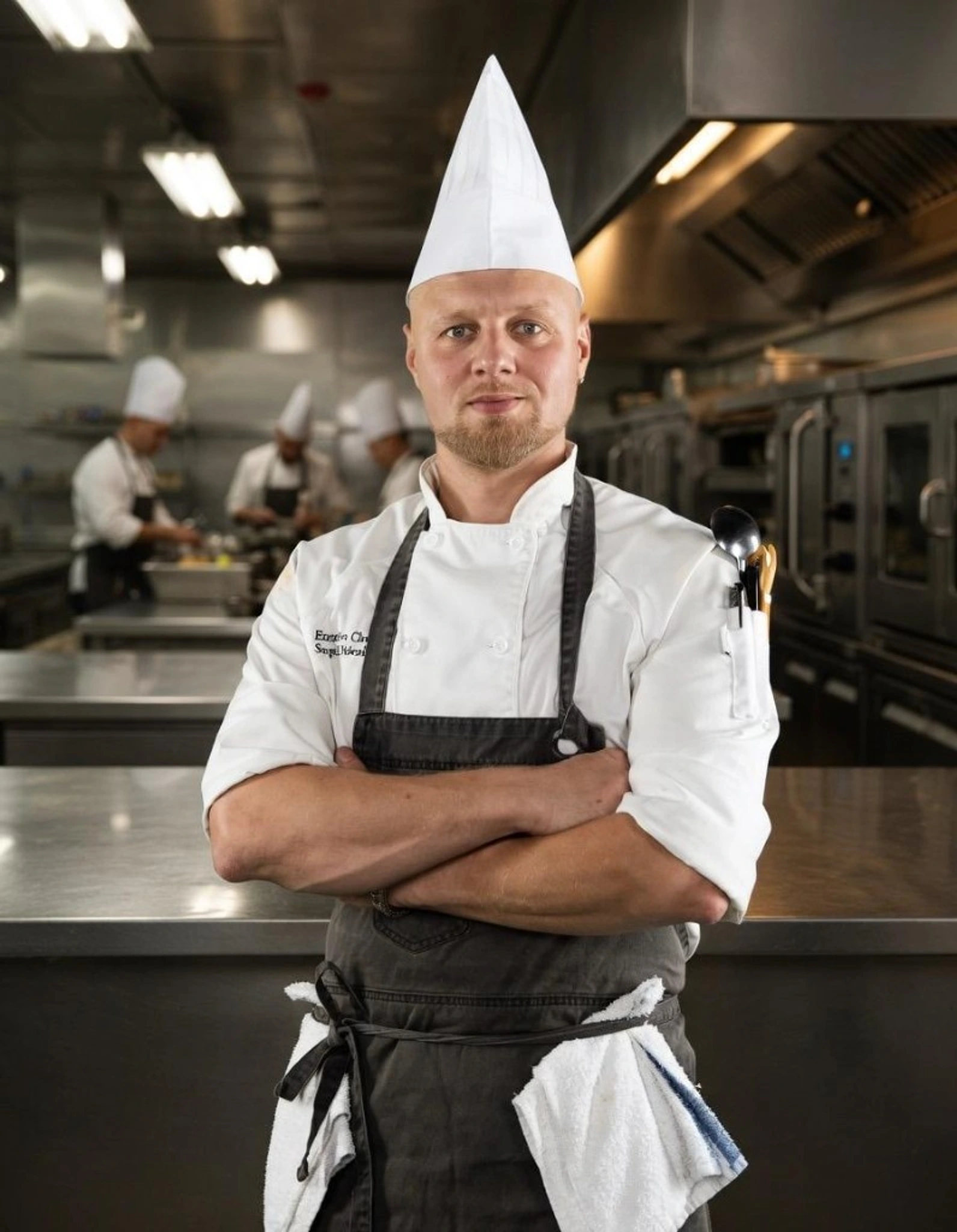 Chef Sergei Didenko in chef whites and toque, professional kitchen